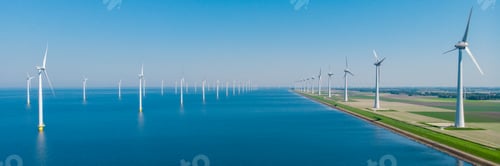 Preview: Windmill turbines at sea seen from a drone aerial view from above at a huge winmill park