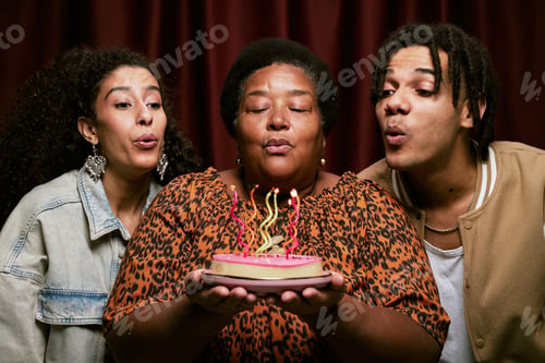 Preview: Multiethnic Young Adults Celebrating Birthday Blowing out Candles in Photo Booth