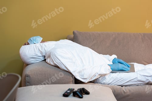 Preview: KYIV, UKRAINE - APRIL 24, 2020: Selective focus of man in hazmat suit and medical mask holding