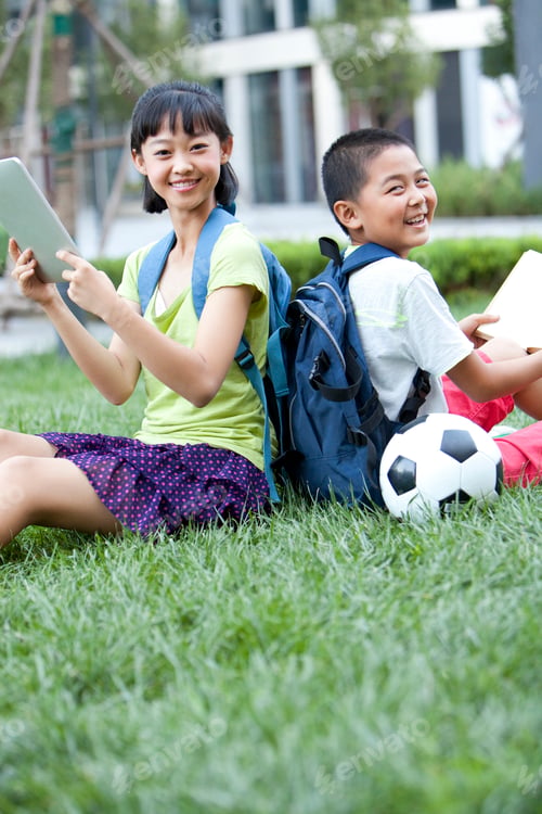 Preview: Schoolchildren learning with books and digital tablet