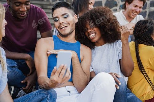 Preview: Happy diverse people having fun using mobile phone outdoor in the city