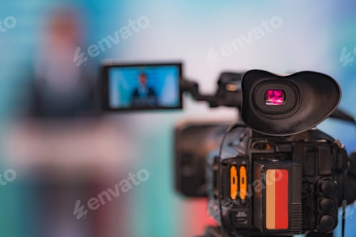 Preview: Camera Recording at a Press Conference.