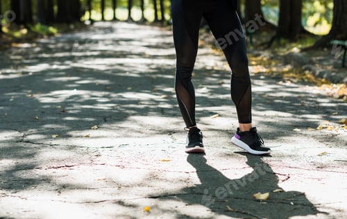 Preview: cropped shot of woman in sportswear at autumn park