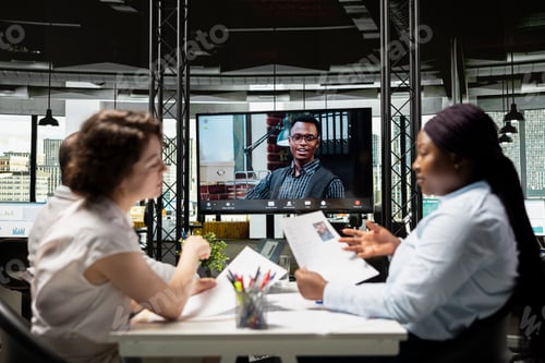 Preview: Black young applicant chatting with recruiting team during remote interview