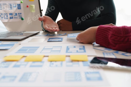 Preview: Group of ux developer and ui designer brainstorming about app interface design at modern office