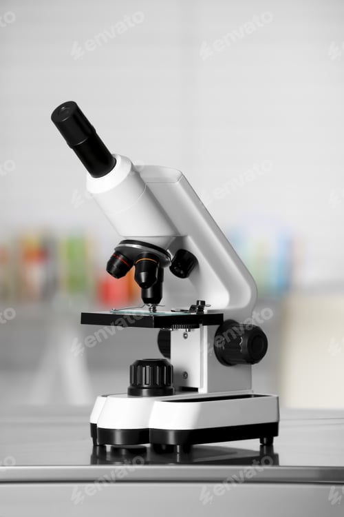Preview: Modern medical microscope on metal table in laboratory