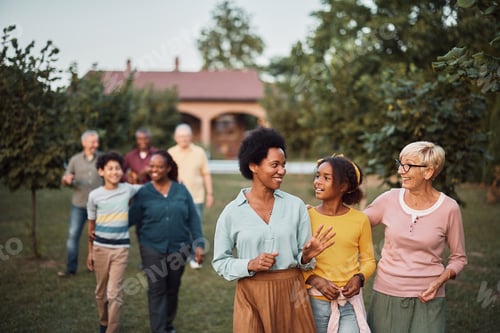 Preview: Happy multiethnic family enjoying while taking a walk in the backyard.