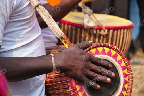 Preview: Closeup of a tribal man playing a local musical instrument at a folk festival in West Bengal.
