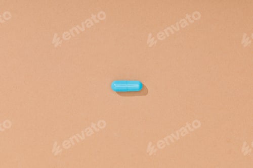 Preview: Top view of blue pill on brown surface