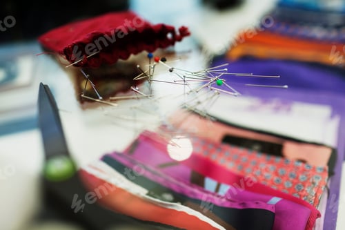 Preview: Close-up of thumbtacks on glass table in clothing store
