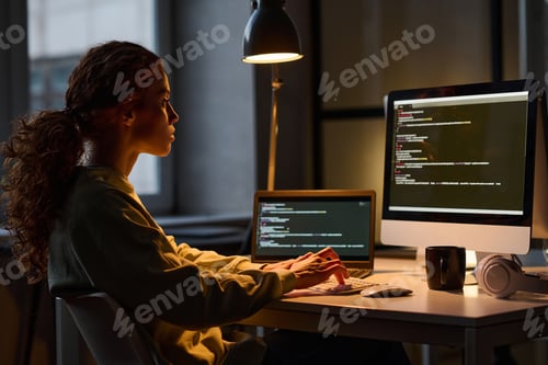 Preview: Woman working on computer in dark office