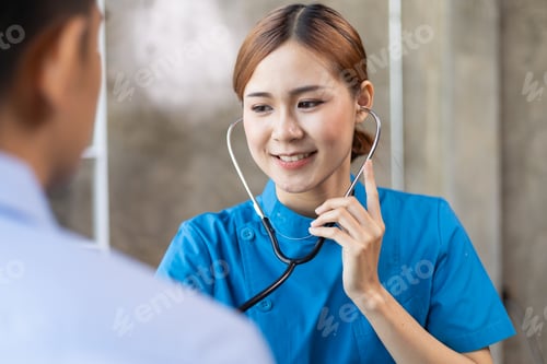 Preview: Doctor using stethoscope examining patient in wheelchair for diagnosis in hospital examination room.