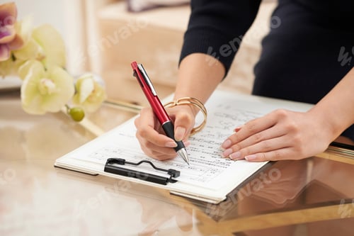 Preview: Woman Signing Contract on Glass Table with Flowers