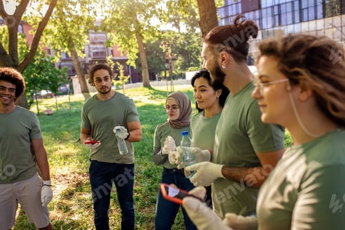 Preview: Portrait of multiethnic group of volunteers with garbage bags cleaning city park.