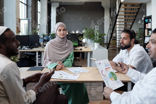 Preview: Group of professionals discussing financial data at working meeting