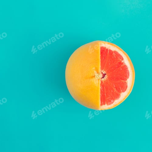 Aperçu: Red grapefruit on bright blue background. Minimal flat lay concept.