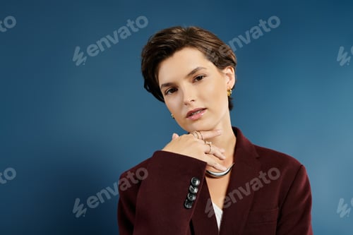 Preview: Elegant winter attire enhances natural beauty of a woman against a stylish blue backdrop