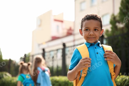 Preview: Cute little child with backpack outdoors. Elementary school