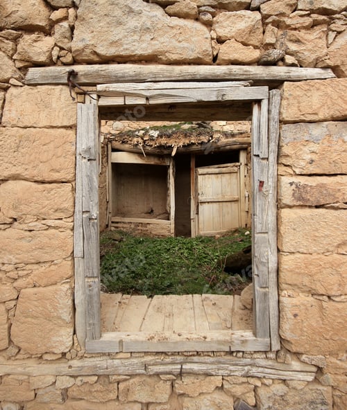 Preview: Ruined old stone house. Wooden door and cabinet visible from the window.