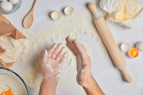 Preview: cropped image of chef applying flour on hands