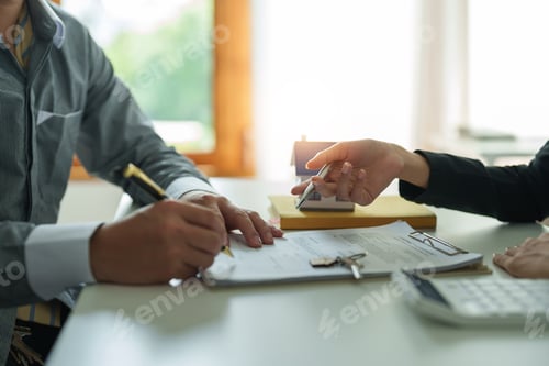 Preview: Real estate agents agree to buy a home and give keys to clients at their agency's offices. Concept