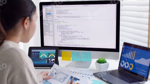 Preview: Asia young business woman sit busy at home office desk work code on desktop