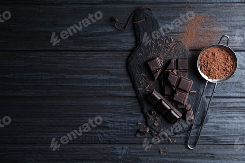 Preview: Flat lay composition with delicious dark chocolate on black wooden table. Space for text