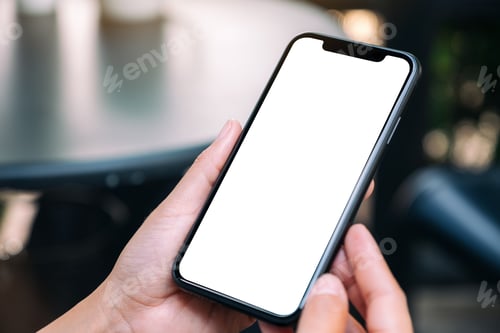 Preview: Mockup image of a woman holding a black mobile phone with blank white desktop screen