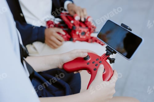 Preview: Anonymous Students Holding Joystick and Robot