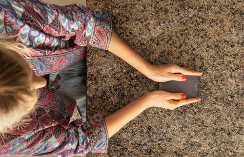 Preview: Top view of a tarot reader holding the deck of tarot cards
