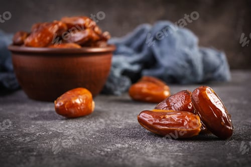 Preview: Dried date fruit in bowl on wooden background. Delicious dates fruit