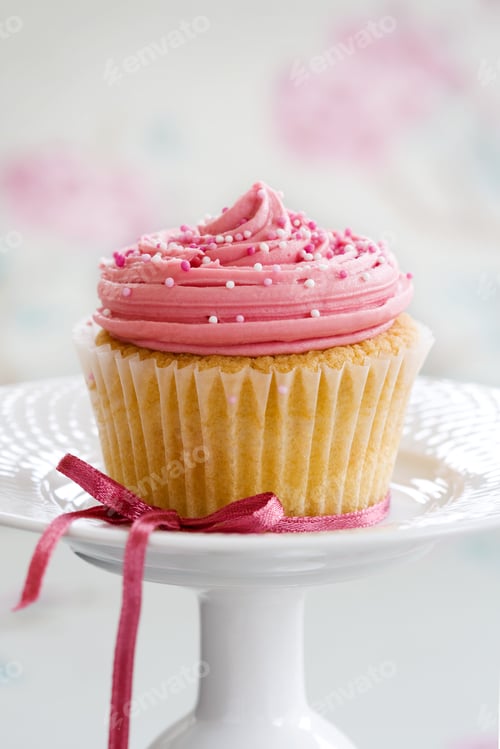 Preview: Delicious Pink Frosted Cupcake with Sprinkles and Bow