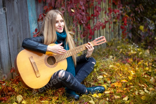 Preview: Girl musician plays the guitar.