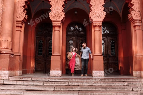Preview: Young stylish pretty couple of hipsters in love are having fun in the city near castle in spring. y