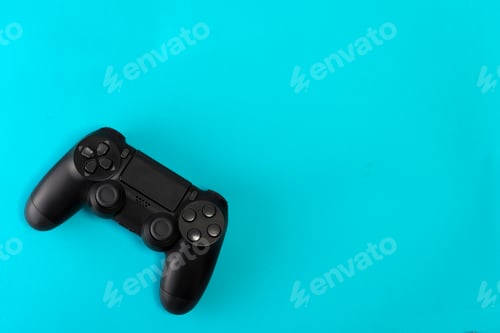 Preview: game controller on blue background studio shot