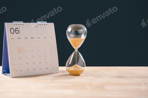 Preview: Hourglass depicts time running out, golden sand grains dropping steadily, calendar prominently