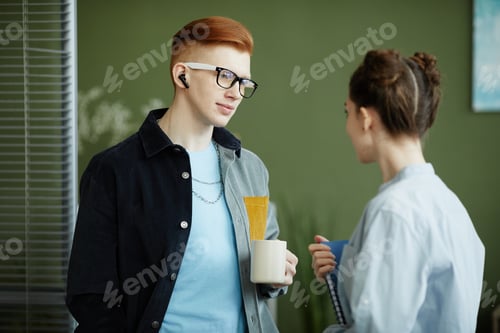 Preview: Young Colleagues Chatting at Work