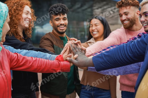 Preview: Multiracial young friends stacking hands together outdoor - Diverse people and unity concept