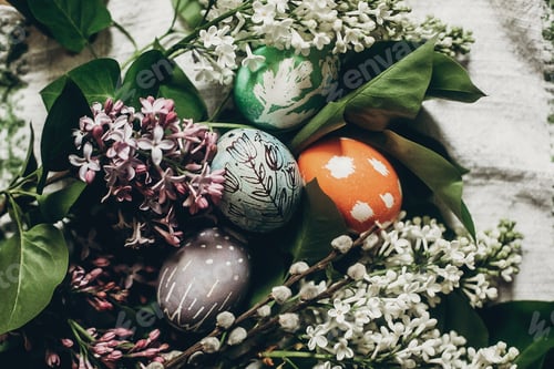 Preview: easter eggs with lilac flowers on rustic background