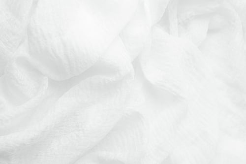 Preview: Soft white delicate textile texture background with elegant drapes and gentle wavy folds