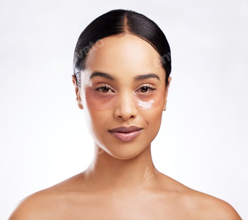 Preview: Studio portrait of a beautiful young woman wearing under-eye patches against a white background