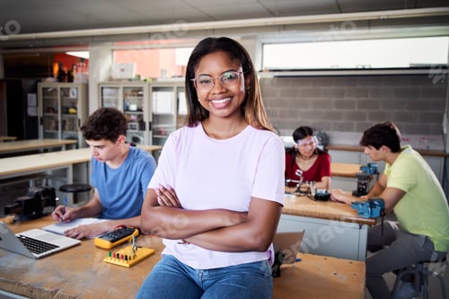 Preview: Portrait of a latina in the classroom looking at the camera with her arms crossed. Young students.