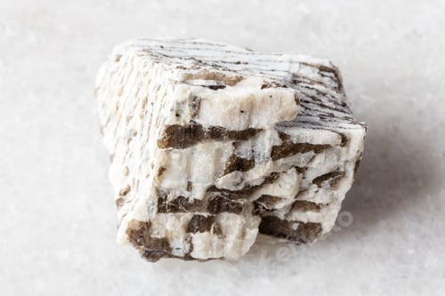 Preview: raw written granite mineral on white marble