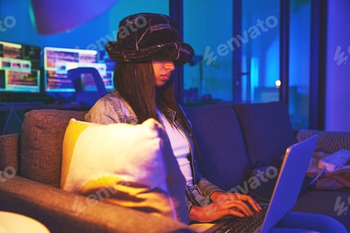 Preview: Woman, hacker and programmer typing on laptop in home at night in neon to hack software. Cybersecur