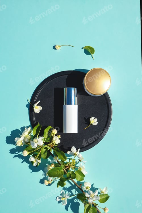 Preview: Face cream, elixir for beauty flat lay on blue background with flowers. Concept of natural cosmetics