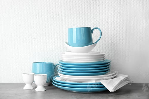 Preview: Set of dinnerware on table against light background. Interior element