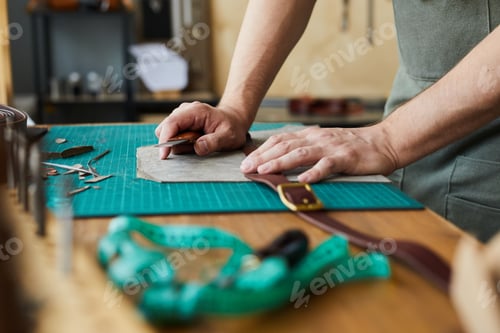 Preview: Man Creating Leather Belt in Workshop