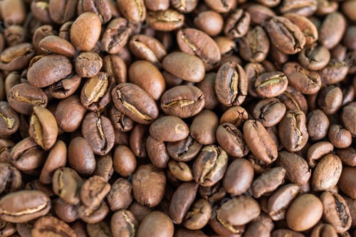 Preview: Texture of dark roast coffee beans for background, top view.