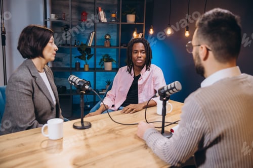 Preview: Three podcasters, two hosts and a guest, are recording a new episode in a professional studio