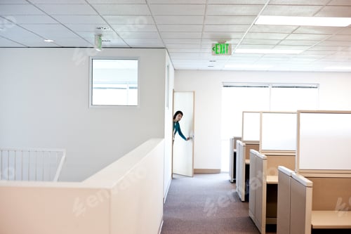 Preview: Office worker coming into cubicle work area of new office.